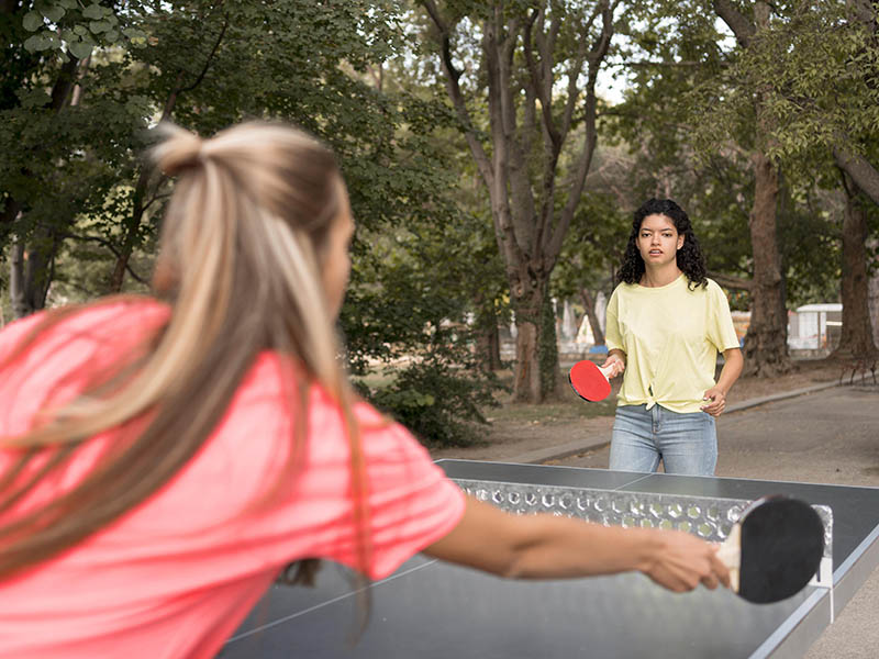 medium shot girls playing table tennis